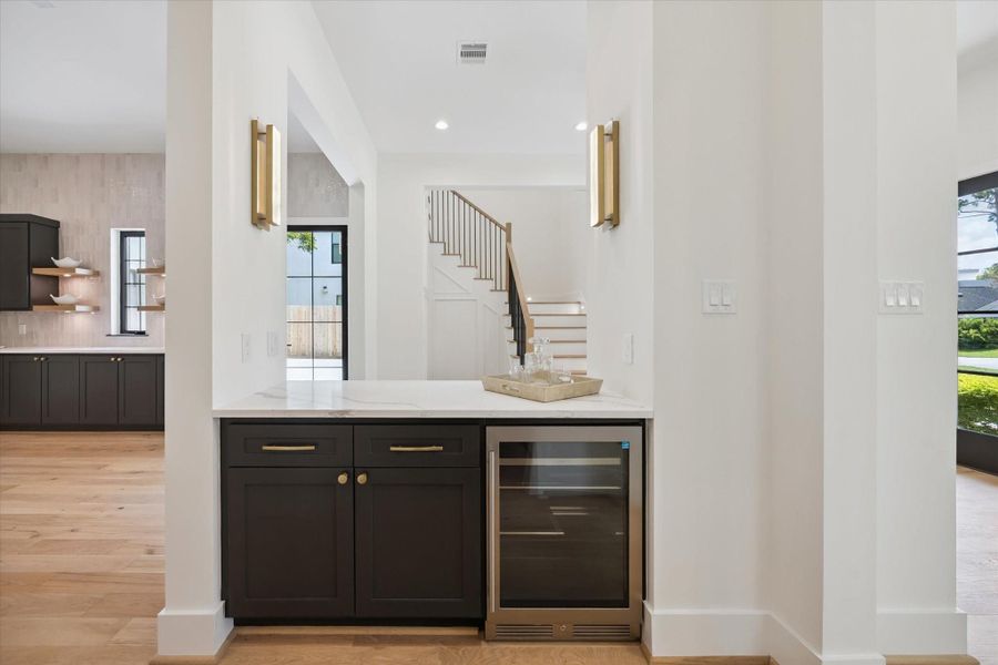 Dry bar area placed perfectly for any catered affair. Ease of access to the entry and on the way to the large entertaining areas but adjacent to the Scullery. Dry bar area placed perfectly for any catered affair. Ease of access to the entry and on the way to the large entertaining areas but adjacent to the Scullery.