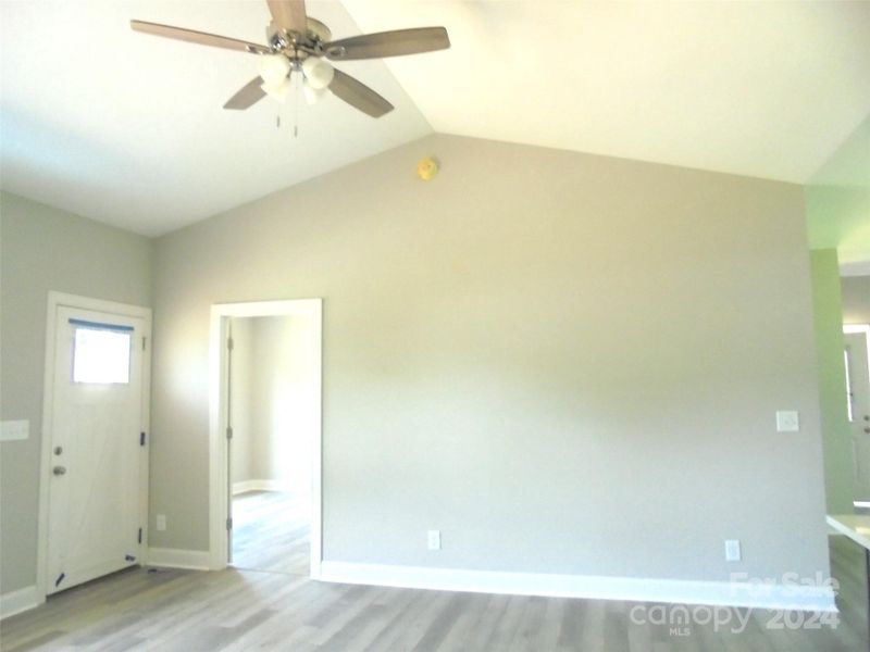 Vaulted Living room- LVP flooring through out this small home with upper end finishes!