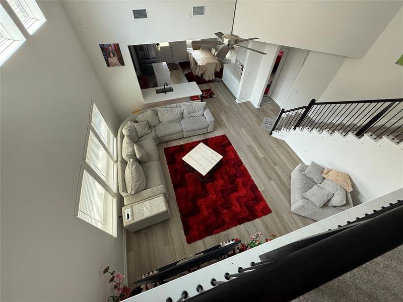 Open-concept living area featuring high ceilings with skylight windows