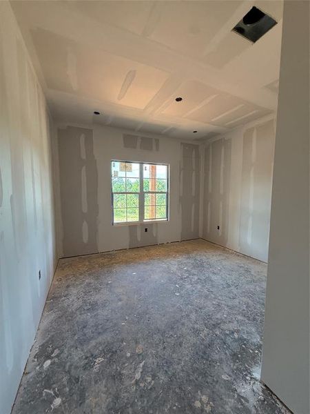 Room under construction with a single window, recessed lighting, and a tray ceiling Room under construction with a single window, recessed lighting, and a tray ceiling
