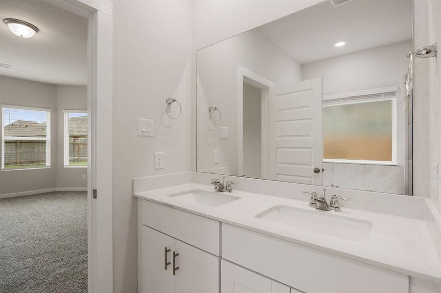 This primary bathroom is definitely move-in ready! Featuring a walk-in shower with tile surround, separate garden tub for soaking after a long day with custom tile detailing, bright cabinets with Quartz countertops, spacious walk-in closet with shelving, high ceilings, custom paint, sleek and modern finishes.