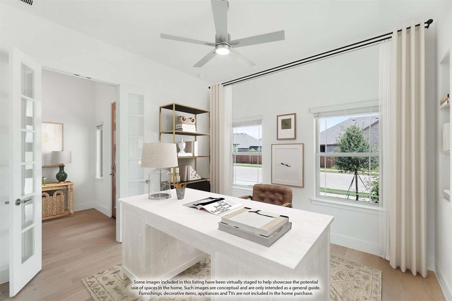 Home office with white desk, ceiling fan, large windows, and French door entry