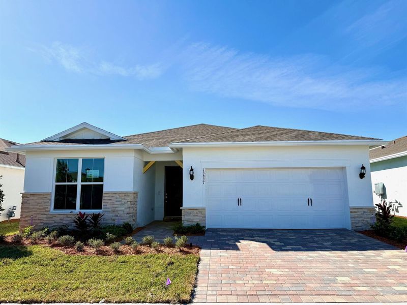Front exterior of a new home in , Port St. Lucie, FL, highlighting curb appeal (Image 1).