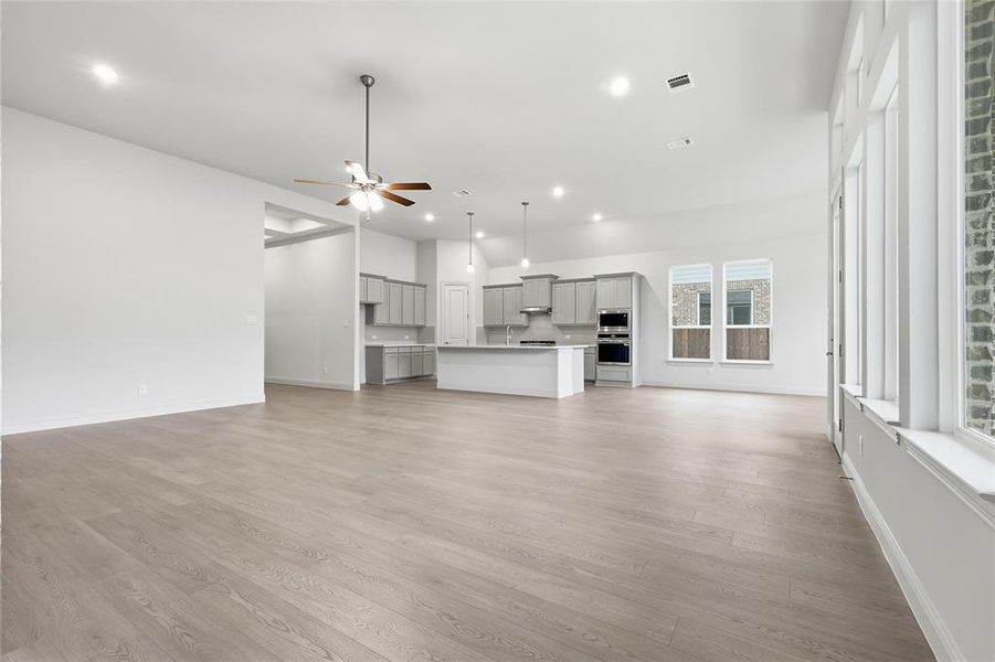 Unfurnished living room with a ceiling fan, light wood-style flooring, and recessed lighting