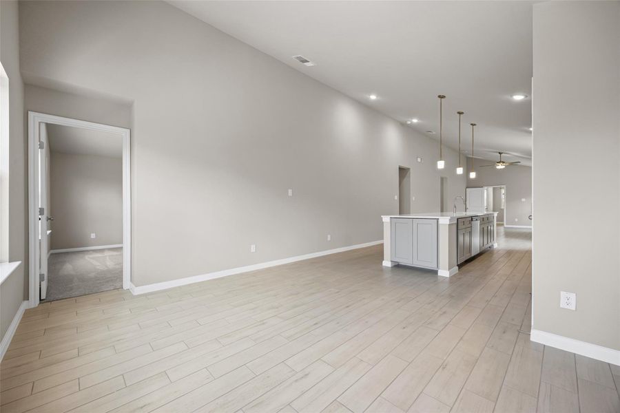 High vaulted ceilings and wood-look flooring define this open-concept main level. High vaulted ceilings and wood-look flooring define this open-concept main level.