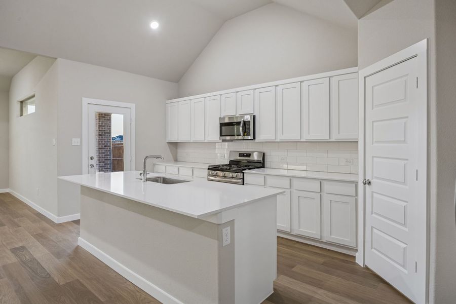 Kitchen in the Wimbledon home plan by Trophy Signature Homes – REPRESENTATIVE PHOTO