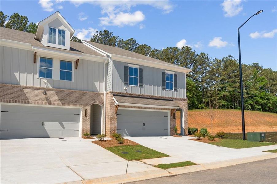 Front exterior of a new home in Wildwood Place, Powder Springs, GA, highlighting curb appeal (Image 21).