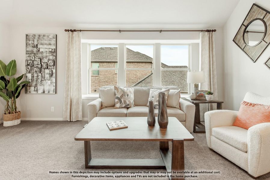 Living room with beige sofa, wood coffee table, large windows, and carpet flooring