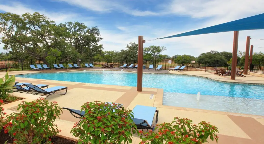 Community pool with a patio