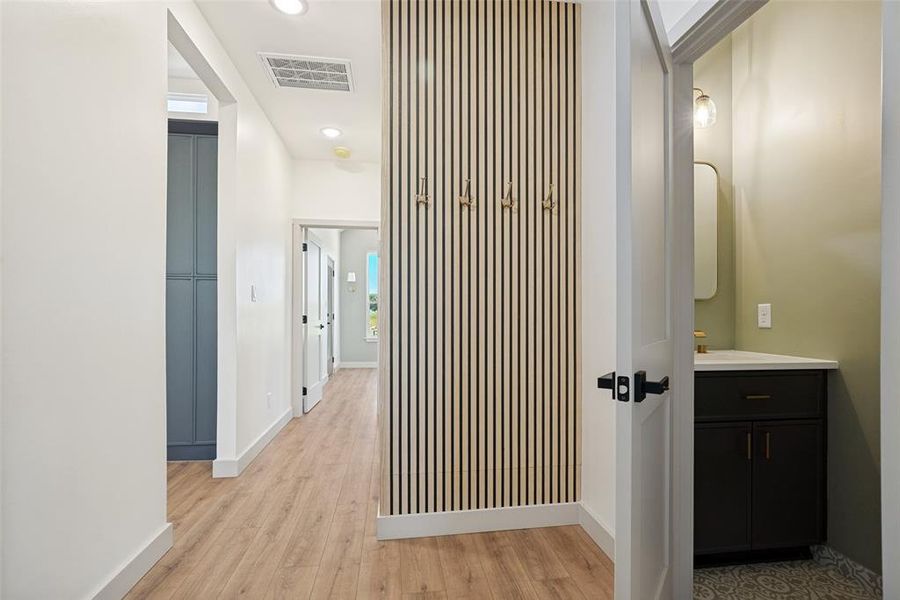 A stylish garage-entry drop zone creates the perfect landing spot for coats, shoes, backpacks, and all of life's daily essentials alongside it you will find the powder room.