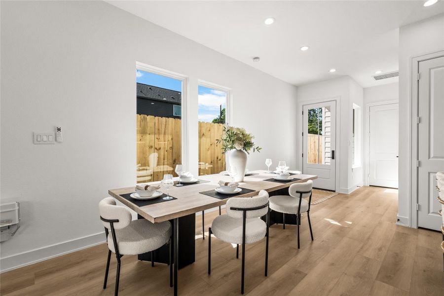 This bright corner of the dining area gets plenty of afternoon sunlight while still keeping your privacy. The clean white walls are ready for your own artwork, and the light oak flooring continues through the space to keep everything matching and modern.