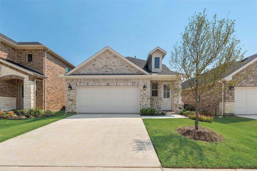 Front exterior of a new home in Spiritas Ranch, Little Elm, TX, highlighting curb appeal (Image 19). Front exterior of a new home in Spiritas Ranch, Little Elm, TX, highlighting curb appeal (Image 19).