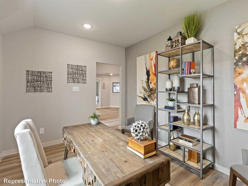 Home office featuring wood-type flooring and lofted ceiling