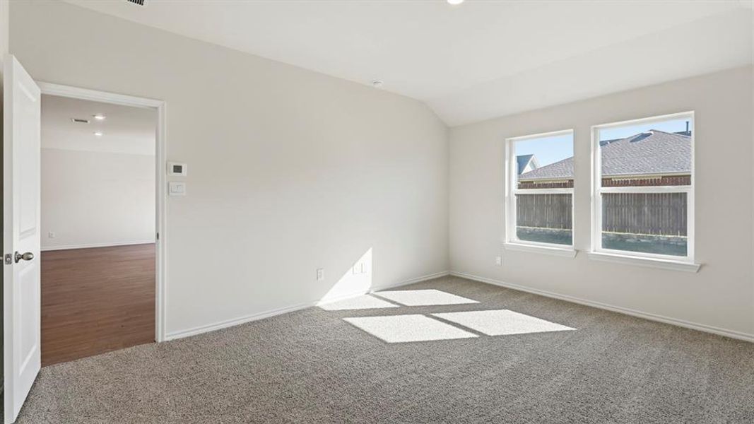 Carpeted spare room with lofted ceiling and recessed lighting Carpeted spare room with lofted ceiling and recessed lighting