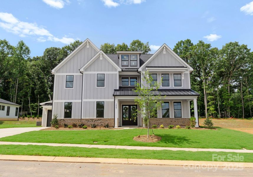 Front exterior of a new home in , Wesley Chapel, NC, highlighting curb appeal (Image 2).
