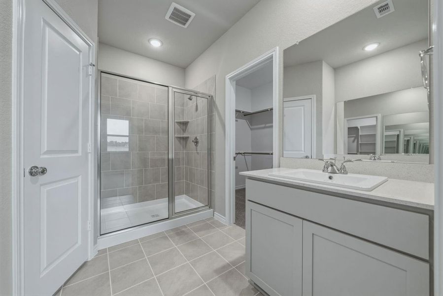 Primary Bathroom in the Cedar home plan by Trophy Signature Homes – REPRESENTATIVE PHOTO