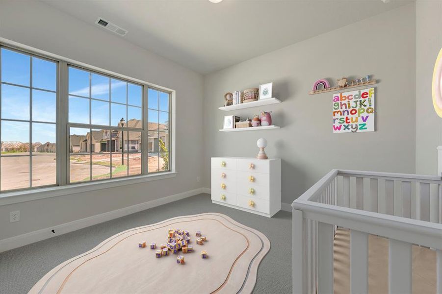 Bedroom featuring a nursery area, dark carpet, and a residential view