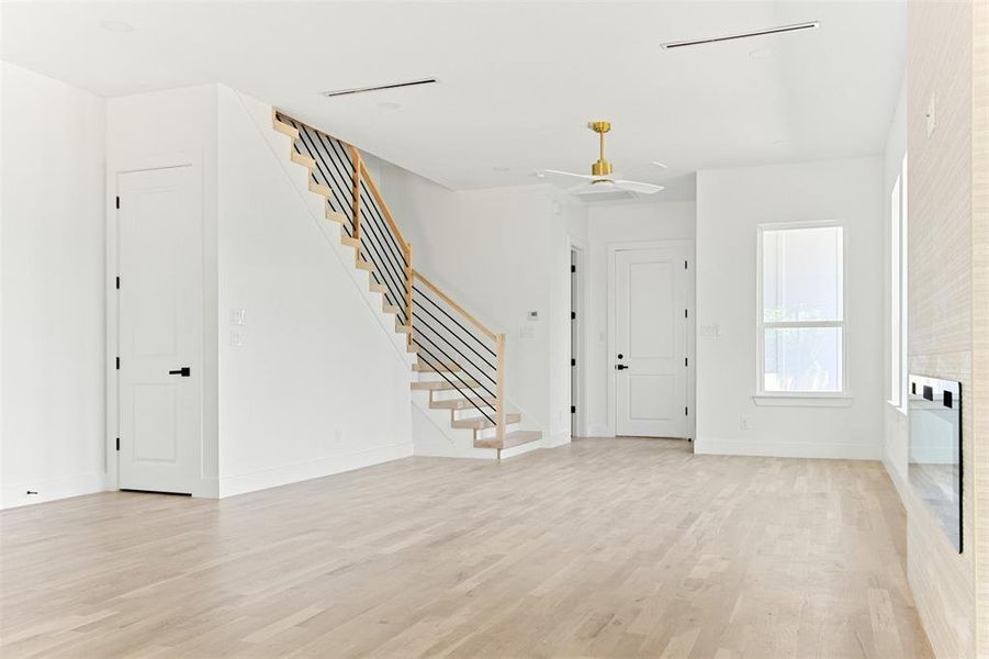 Foyer with light hardwood / wood-style floors and ceiling fan