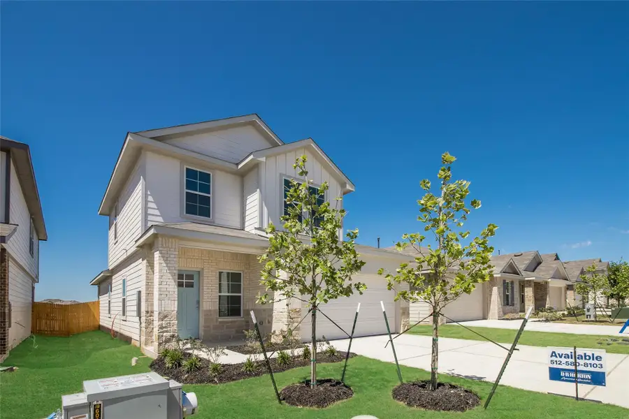 Front exterior of a new home in Prairie Lakes, Buda, TX, highlighting curb appeal (Image 1). Front exterior of a new home in Prairie Lakes, Buda, TX, highlighting curb appeal (Image 1).