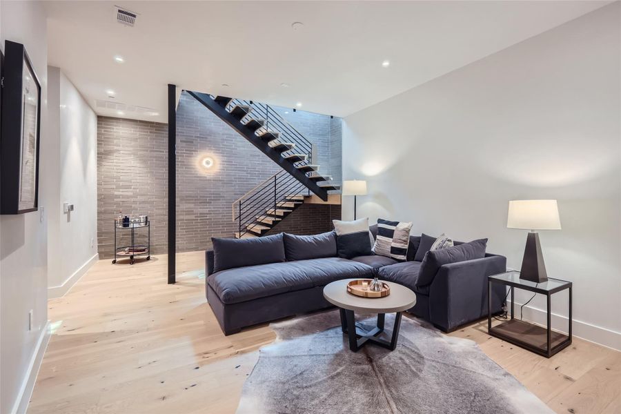 Hardwood floors and a striking modern staircase define this elegant and contemporary living area. Hardwood floors and a striking modern staircase define this elegant and contemporary living area.