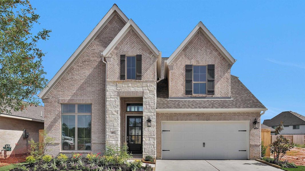 Front exterior of a new home in Candela South 50', Richmond, TX, highlighting curb appeal (Image 14). Front exterior of a new home in Candela South 50', Richmond, TX, highlighting curb appeal (Image 14).
