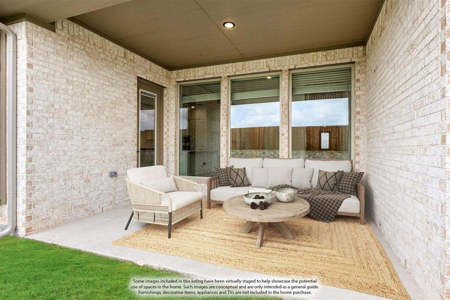 Covered patio with brick walls, outdoor seating set, round wood coffee table, and jute rug Covered patio with brick walls, outdoor seating set, round wood coffee table, and jute rug