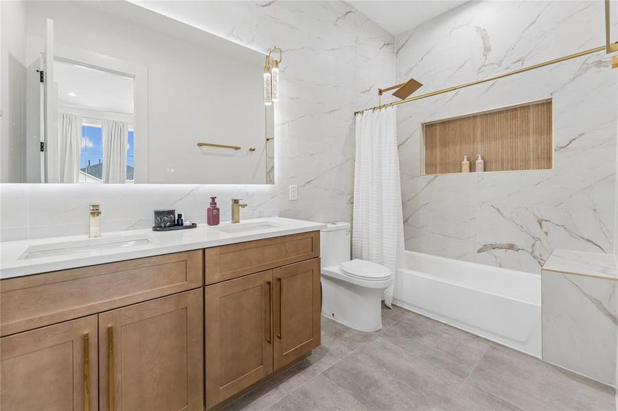 Ensuite bathroom with floor to ceiling quartz tile, dual sinks and lots of storage Ensuite bathroom with floor to ceiling quartz tile, dual sinks and lots of storage