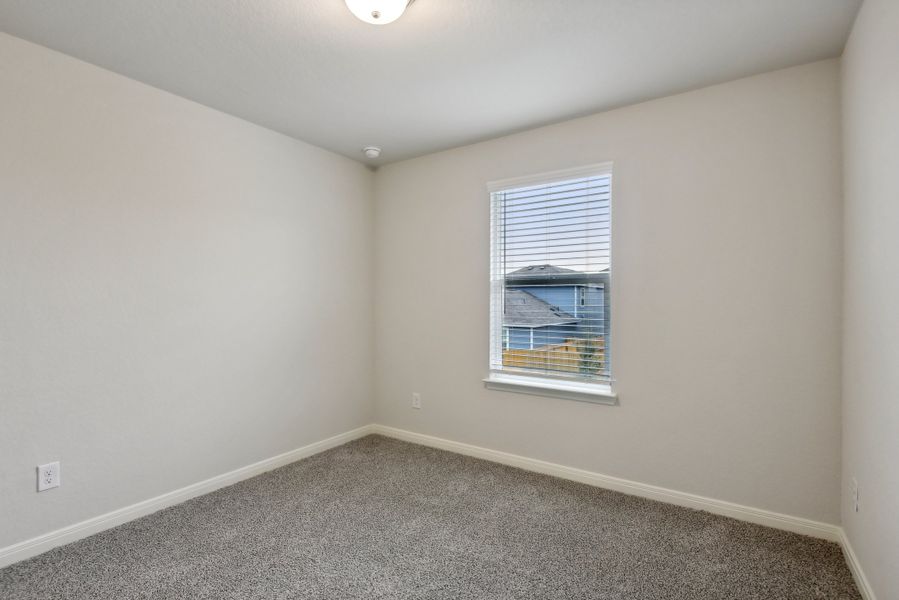 Guest bedroom in the Red River floorplan at a Meritage Homes community.