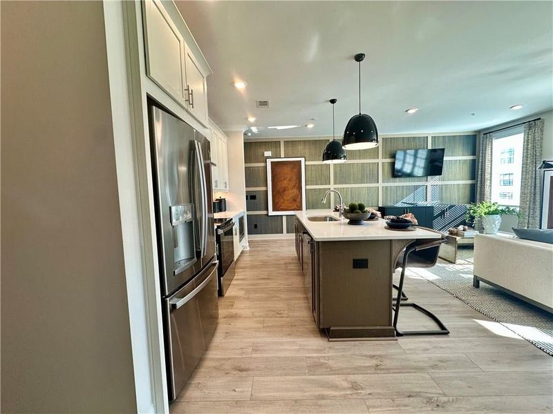 Open concept floor plan makes this space ideal entertainment *Images shown are from a decorated model of the same floor plan. Design selections and color packages will vary by home.*