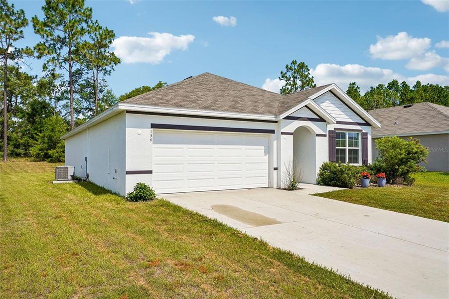 Front exterior of a new home in Lake Diamond, Ocala, FL, highlighting curb appeal (Image 23).
