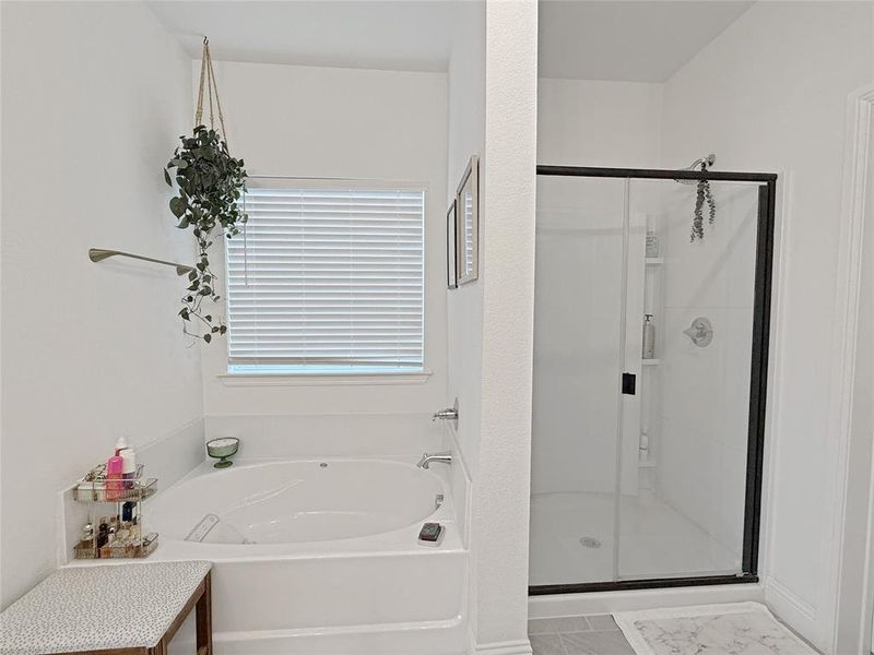 Full bath with a stall shower and a bath Full bath with a stall shower and a bath