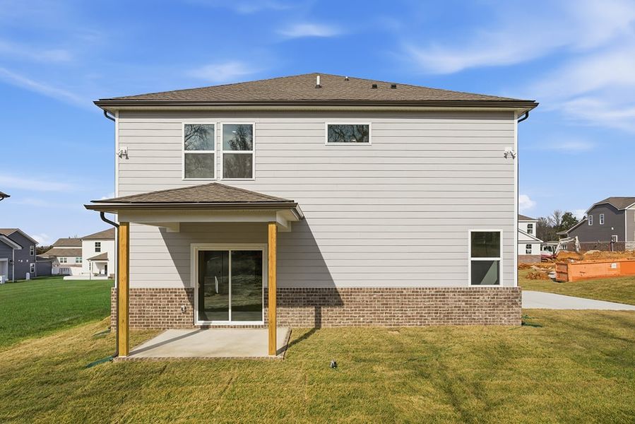 A small house with a brick wall.