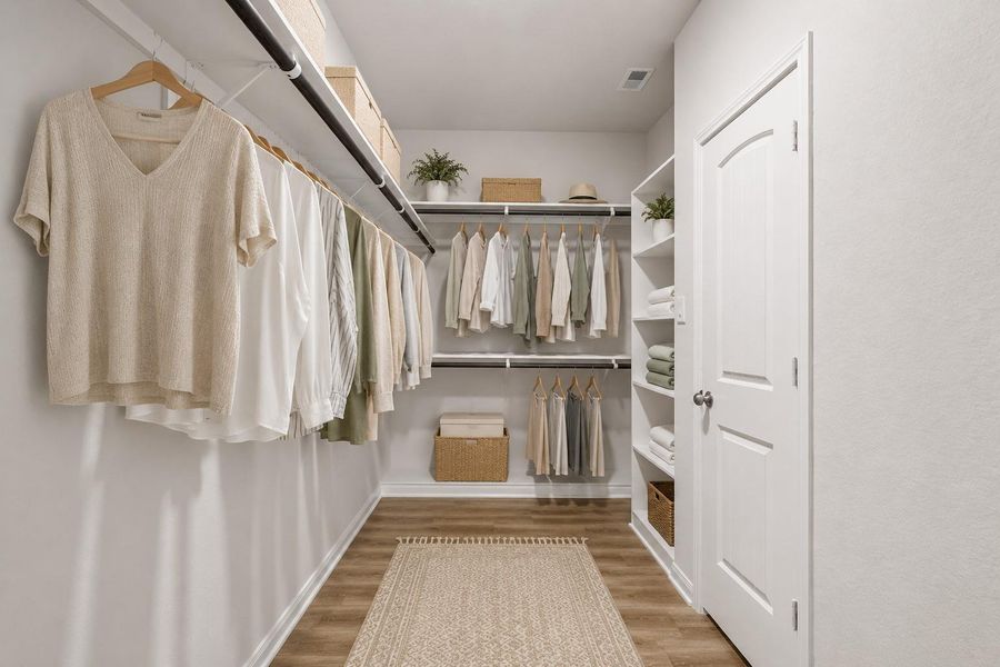 The LVP flooring continues in the primary closet also (*virtually staged)