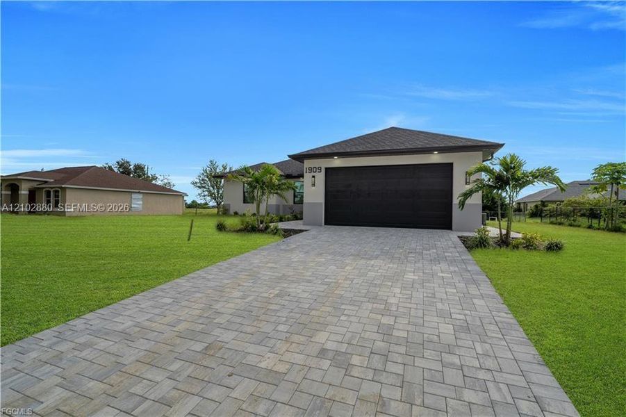 Front exterior of a new home in , Cape Coral, FL, highlighting curb appeal (Image 2). Front exterior of a new home in , Cape Coral, FL, highlighting curb appeal (Image 2).