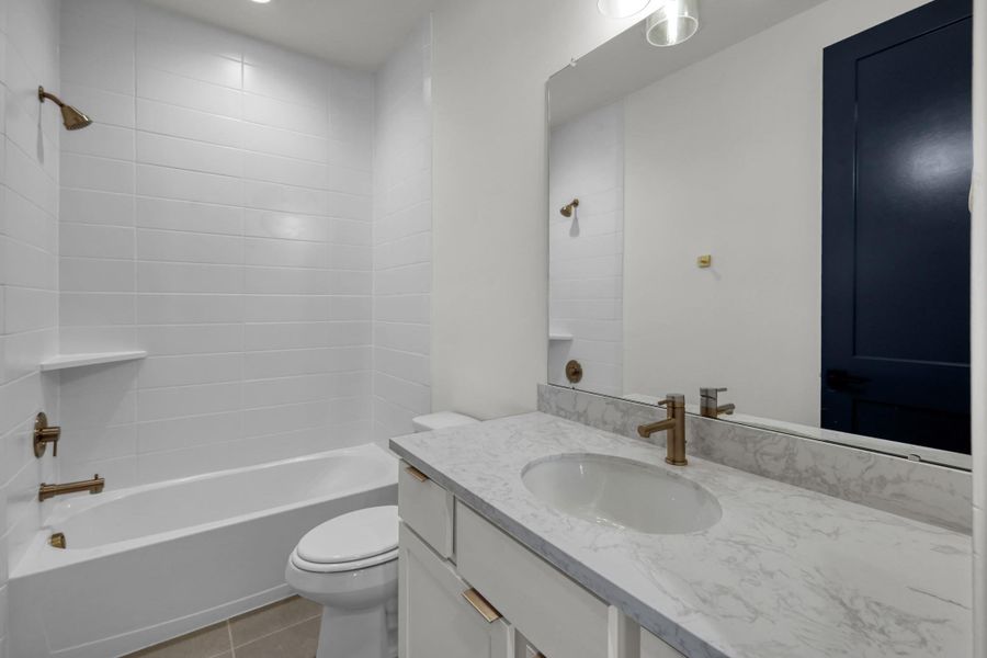 Additional full bath with white cabinetry and modern lighting. Additional full bath with white cabinetry and modern lighting.