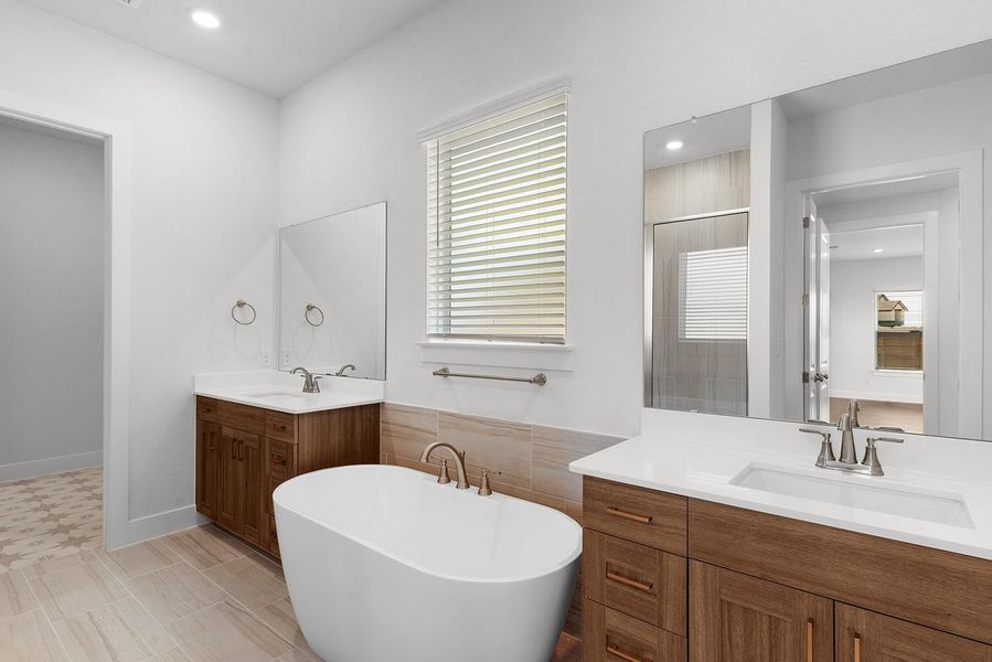 Indulge in a tranquil retreat featuring a deep soaking tub and dual vanities, perfect for unwinding.