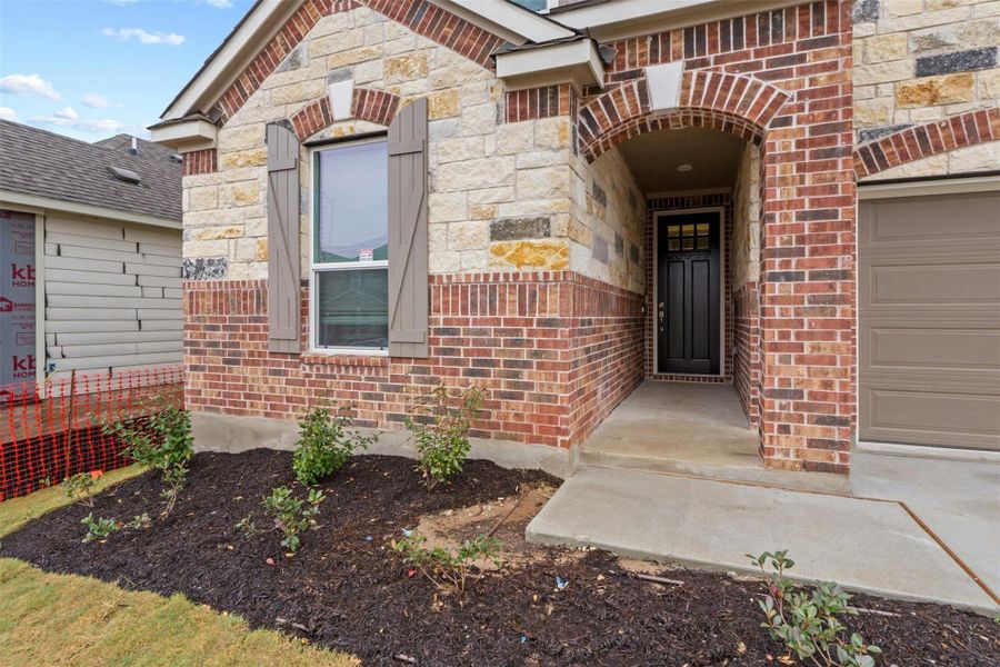 Front exterior of a new home in McKinney Crossing, Austin, TX, highlighting curb appeal (Image 23). Front exterior of a new home in McKinney Crossing, Austin, TX, highlighting curb appeal (Image 23).