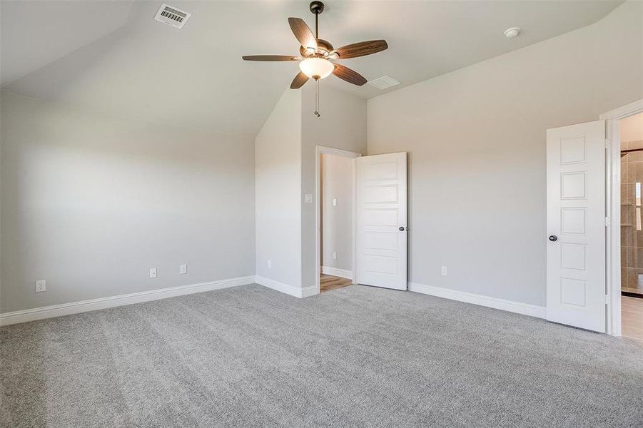 Unfurnished bedroom featuring high vaulted ceiling, light carpet, and ceiling fan