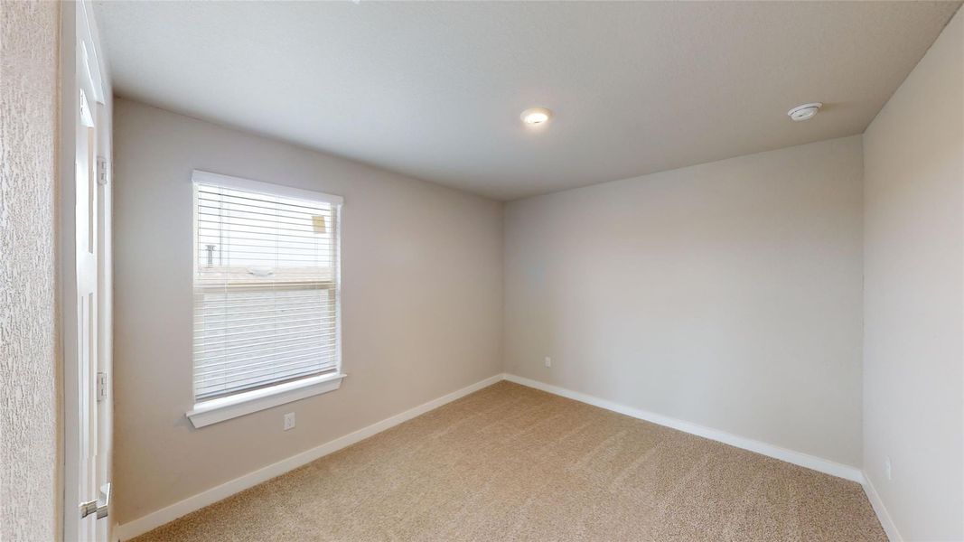 Spare room with baseboards and light carpet