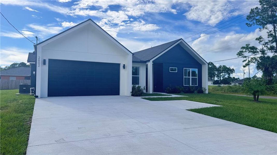 Front exterior of a new home in , Palm Bay, FL, highlighting curb appeal (Image 1).