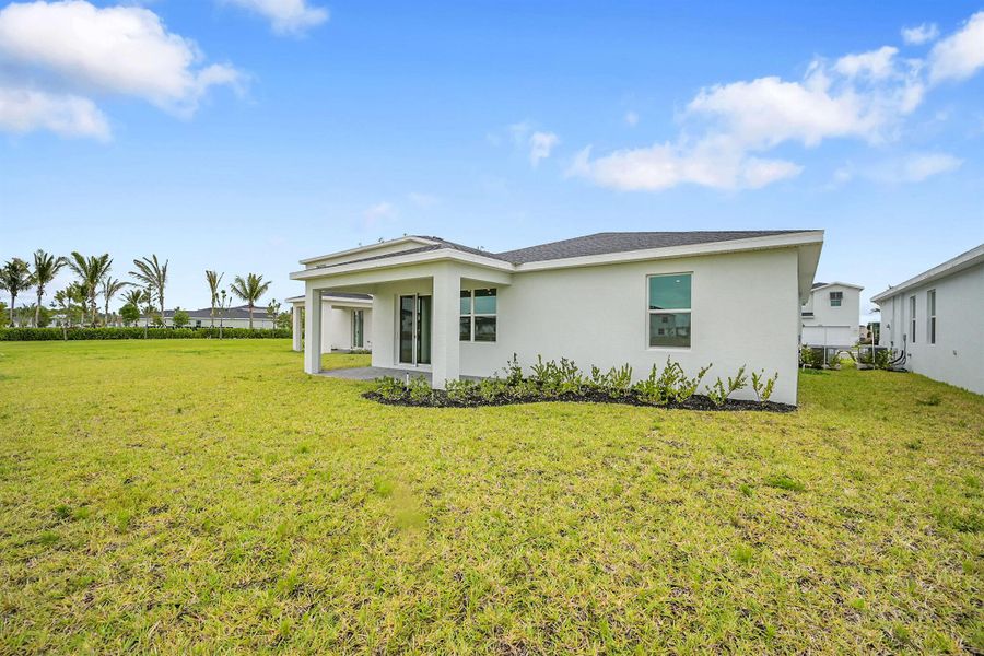 Front exterior of a new home in Seagrove: The Indies, Fort Pierce, FL, highlighting curb appeal (Image 2). Front exterior of a new home in Seagrove: The Indies, Fort Pierce, FL, highlighting curb appeal (Image 2).