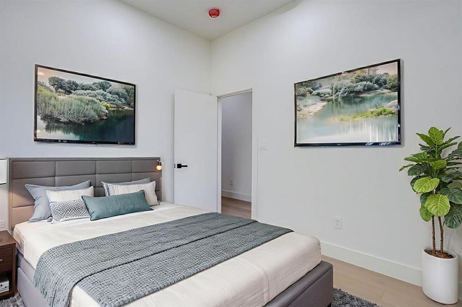 Bedroom featuring baseboards and light wood-type flooring