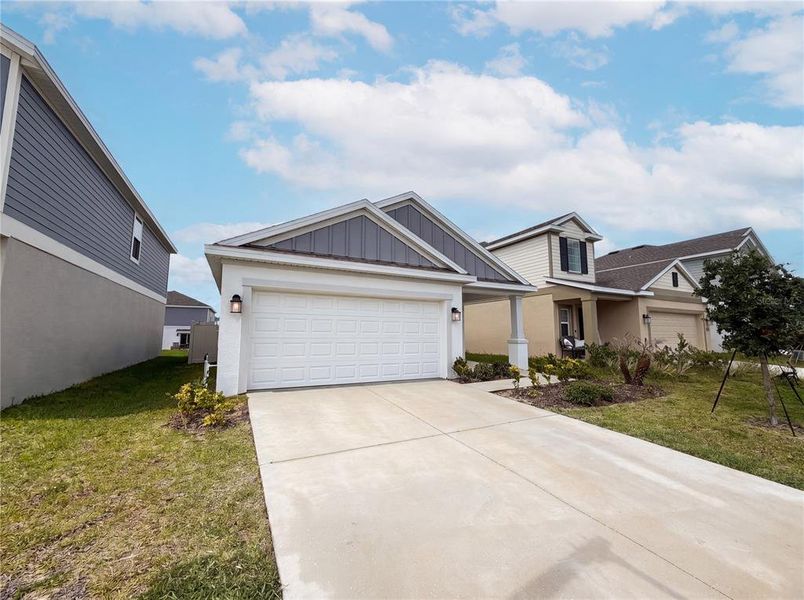 Front exterior of a new home in Cascades, Davenport, FL, highlighting curb appeal (Image 15). Front exterior of a new home in Cascades, Davenport, FL, highlighting curb appeal (Image 15).