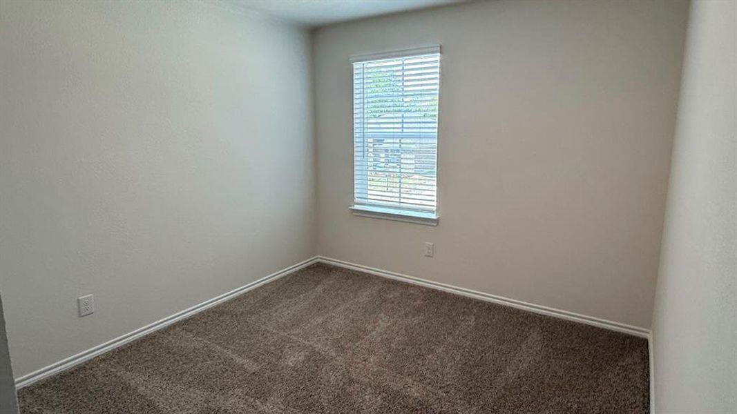 Unfurnished room with carpet floors and baseboards Unfurnished room with carpet floors and baseboards