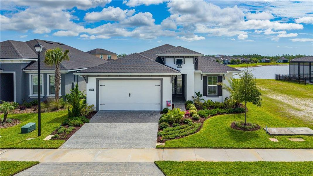 Front exterior of a new home in Mosaic, Daytona Beach, FL, highlighting curb appeal (Image 23). Front exterior of a new home in Mosaic, Daytona Beach, FL, highlighting curb appeal (Image 23).