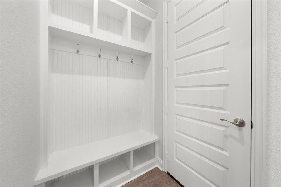 Mudroom with luxury vinyl floors which leads into the garage.