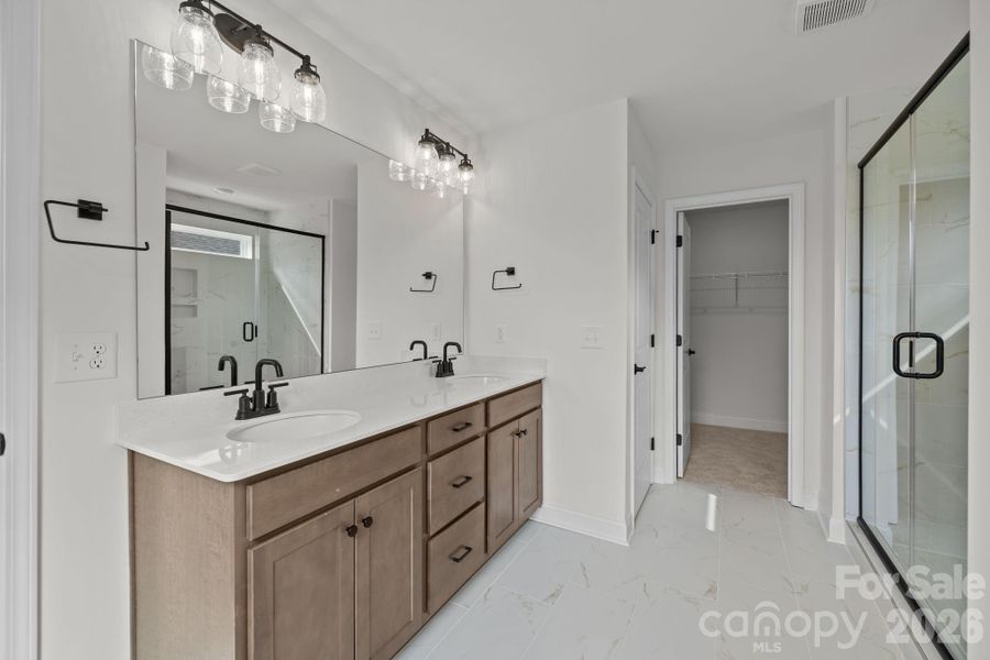 Primary Bath with oversized walk in shower, walk in closet, and large linen closet