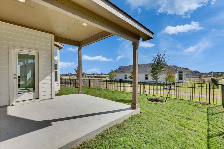Fenced backyard featuring a patio area and a residential view Fenced backyard featuring a patio area and a residential view