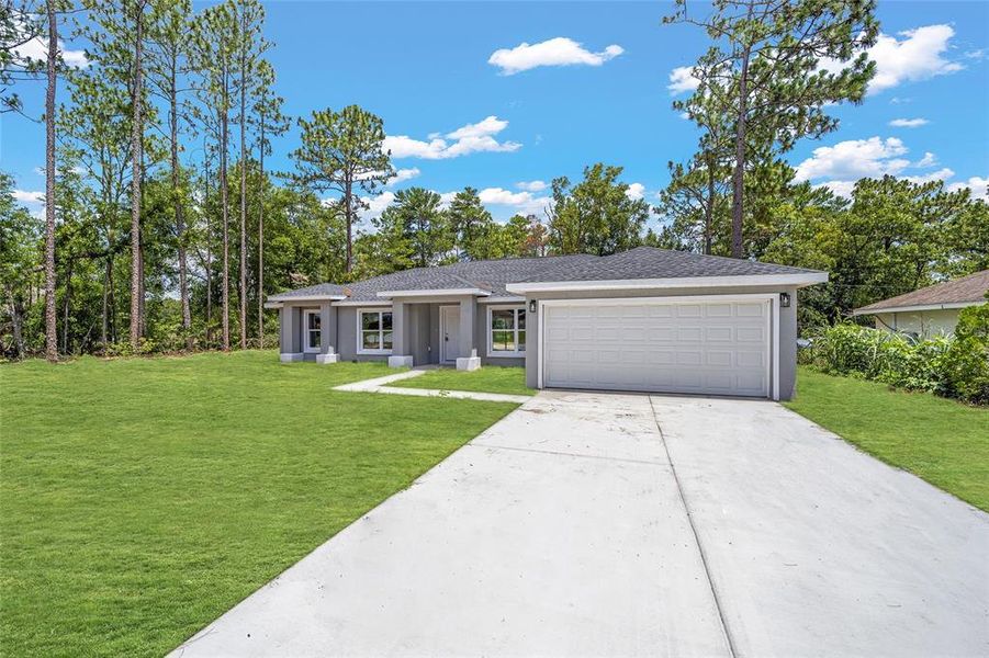 Front exterior of a new home in , Dunnellon, FL, highlighting curb appeal (Image 2).