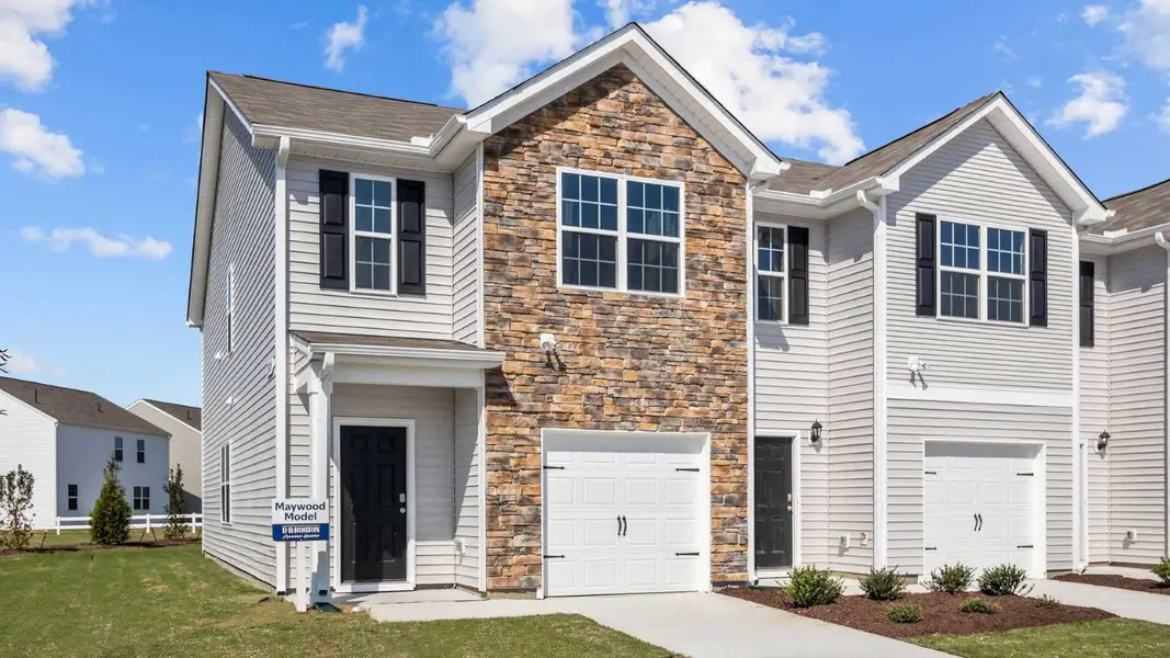 Front exterior of a new home in The Townes at Ridgewood Farms, Winterville, NC, highlighting curb appeal (Image 1). Front exterior of a new home in The Townes at Ridgewood Farms, Winterville, NC, highlighting curb appeal (Image 1).